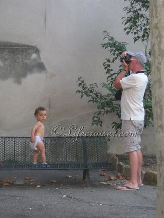 Mr Lifecruiser as a photographer is watched by kid, Medieval village, Southern France, Copyright Lifecruiser.com