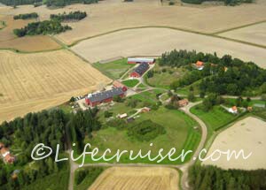Typical Falu red Swedish farm from air